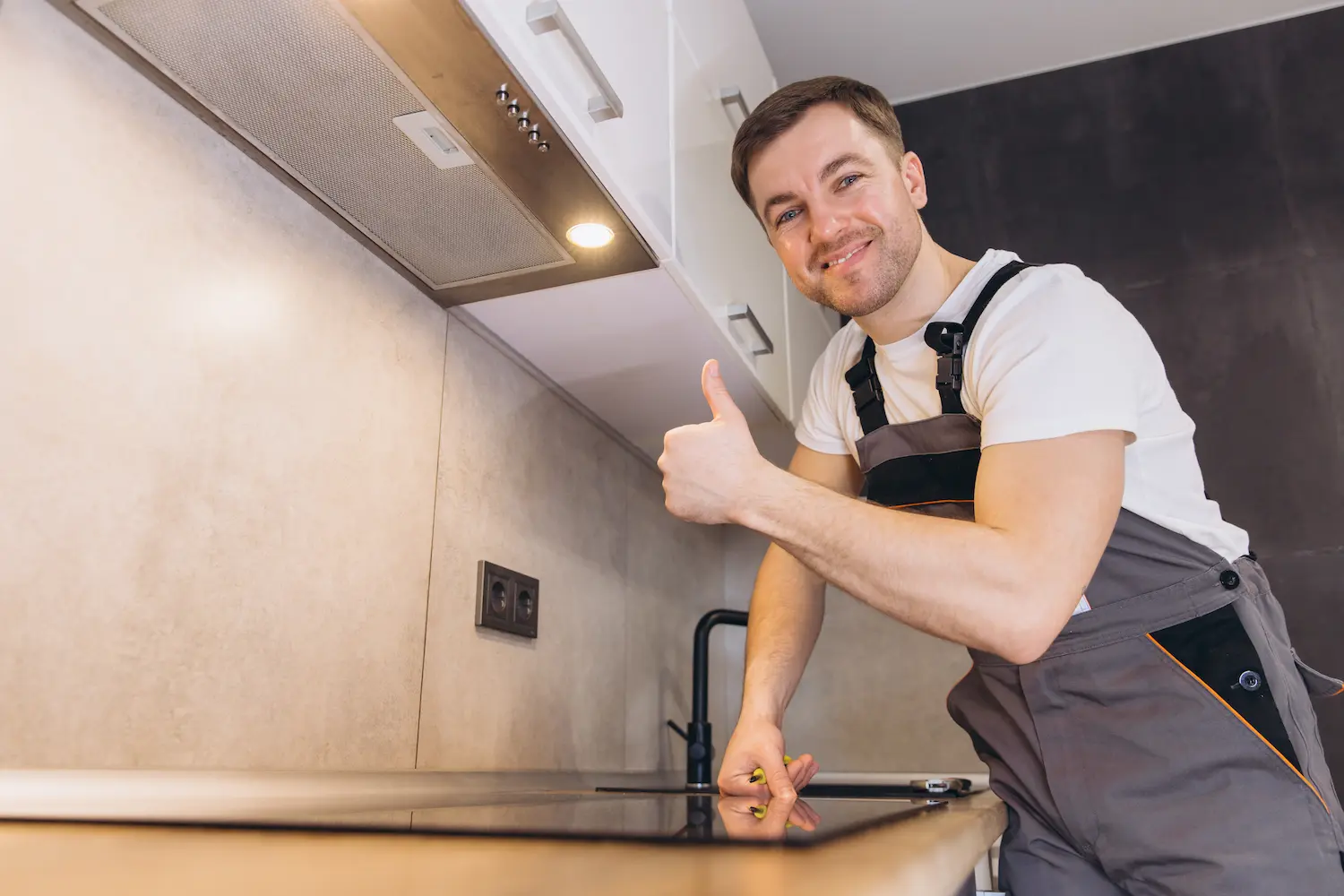 plumber gesturing thumbs up while installing induc 2025 08 10 08 08 32 utc