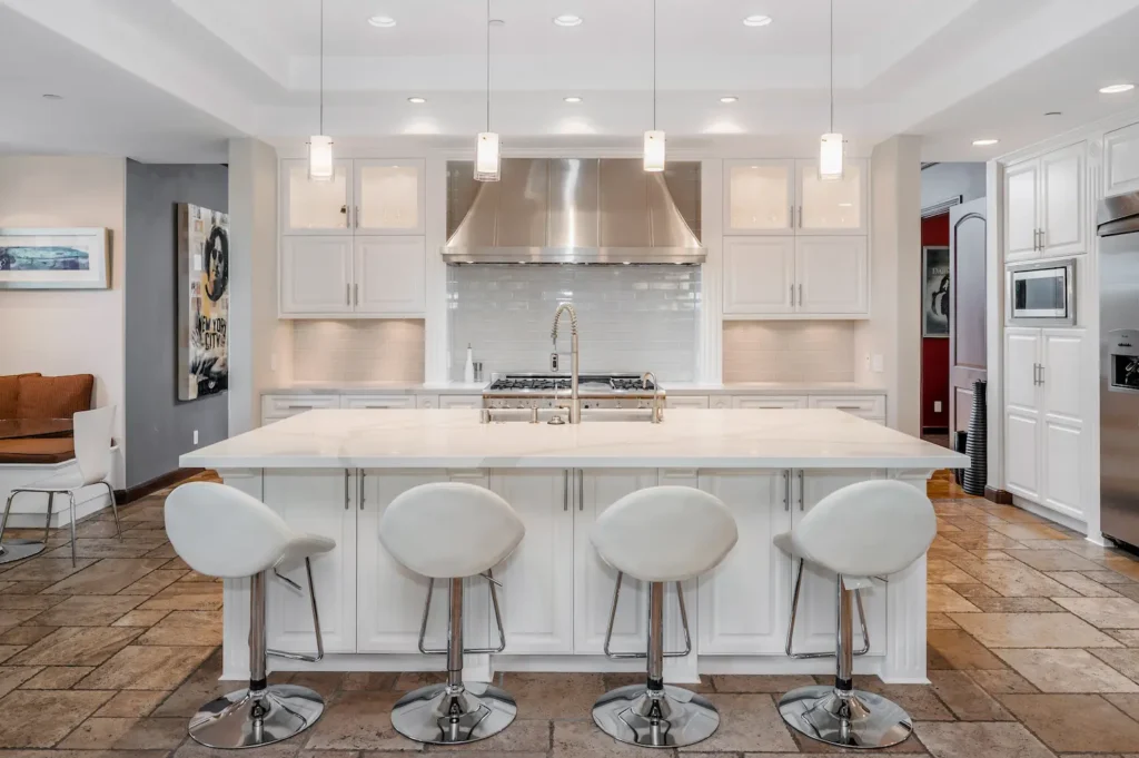 two white bar stools next to a large kitchen islan 2025 02 02 09 31 40 utc